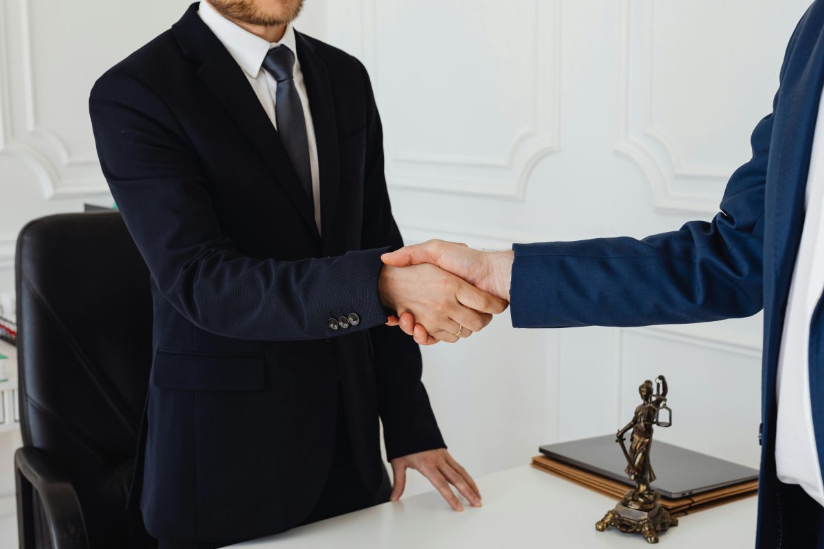 Business professionals shaking hands after reaching a contract agreement