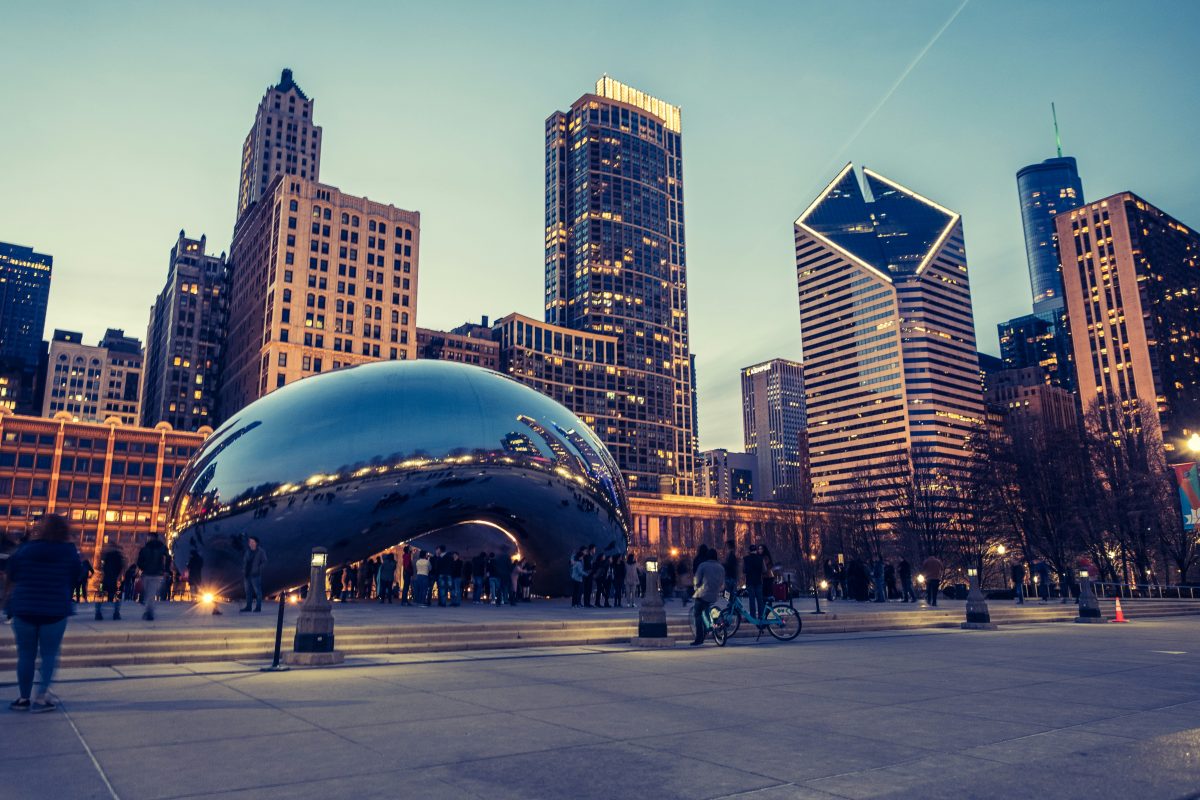 Cloud Gate sculpture in Millennium Park with the Chicago skyline in the background