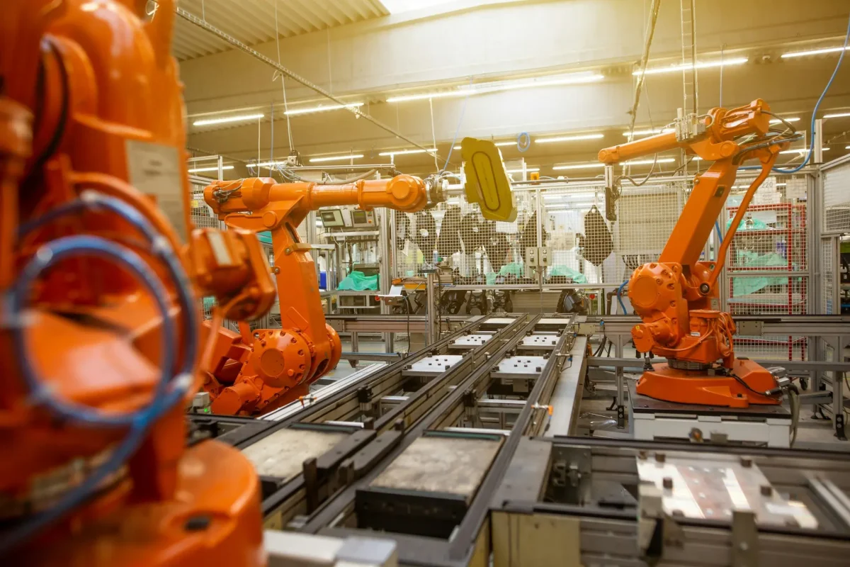 Industrial manufacturing facility with robotic arms and automated production line, representing Chicago business and commercial operations